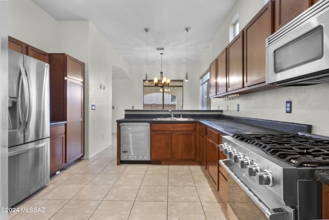 kitchen featuring sink, stainless steel appliances, a chandelier, decorative light fixtures, and light tile patterned floors