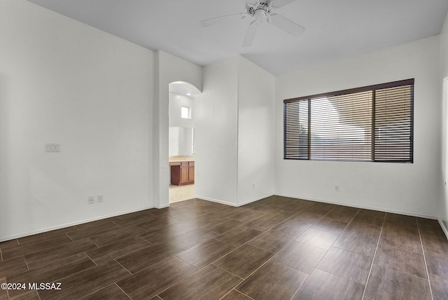 unfurnished room featuring ceiling fan and dark wood-type flooring