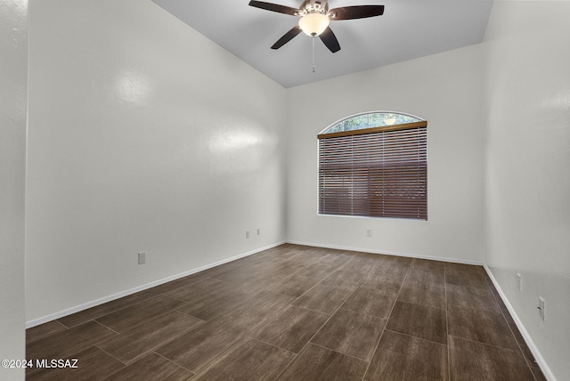 spare room with ceiling fan and dark wood-type flooring