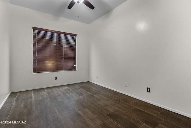 empty room featuring ceiling fan and dark wood-type flooring