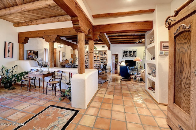 living room featuring wood ceiling, light tile patterned flooring, beamed ceiling, and ornate columns