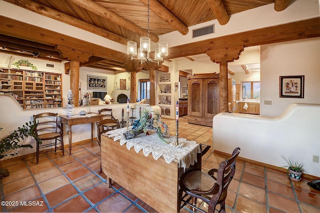 interior space featuring wood ceiling, a chandelier, beamed ceiling, and ornate columns