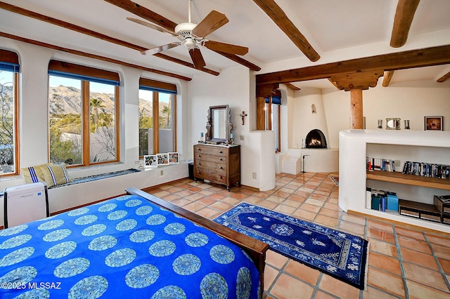 bedroom featuring a mountain view, tile patterned floors, and beam ceiling