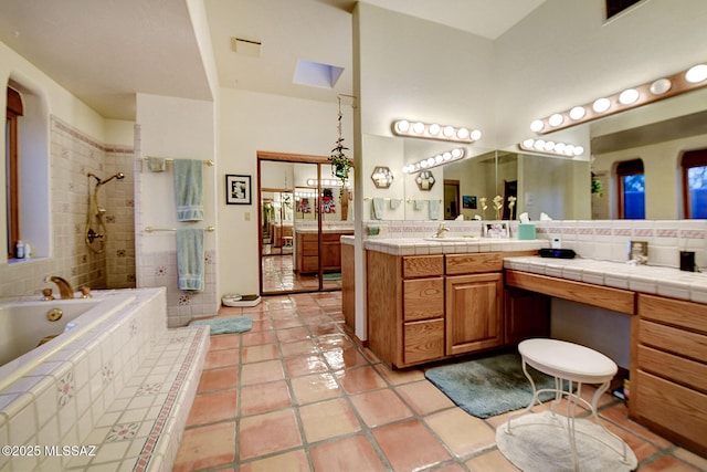 bathroom featuring vanity, tile patterned flooring, plus walk in shower, and a high ceiling