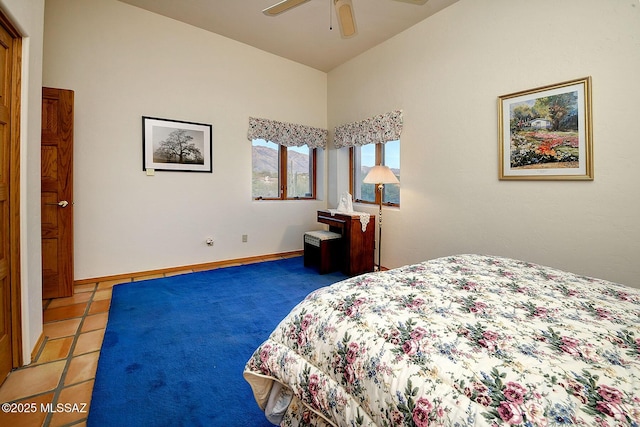 tiled bedroom featuring vaulted ceiling and ceiling fan