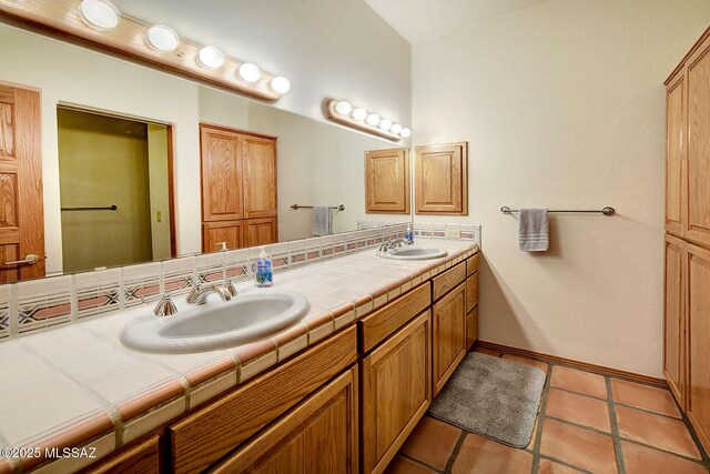 bathroom featuring tile patterned flooring and vanity