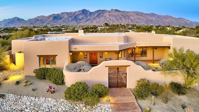 adobe home featuring a mountain view