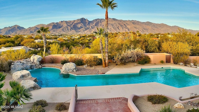 view of pool featuring a mountain view and a patio area