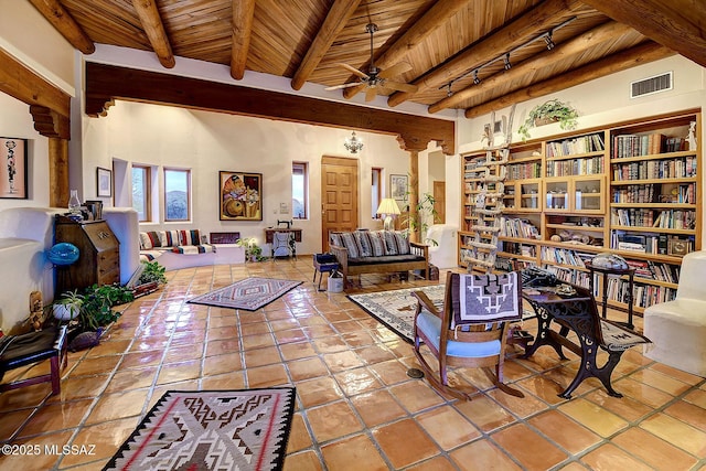 living area with beamed ceiling, ceiling fan, tile patterned floors, and wooden ceiling