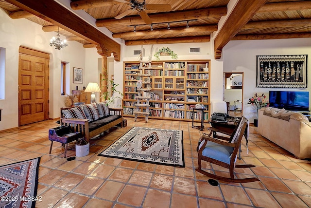 living room featuring rail lighting, tile patterned flooring, wooden ceiling, beam ceiling, and ceiling fan with notable chandelier