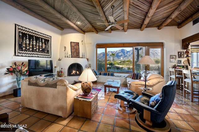 living room with beam ceiling, wooden ceiling, and ceiling fan