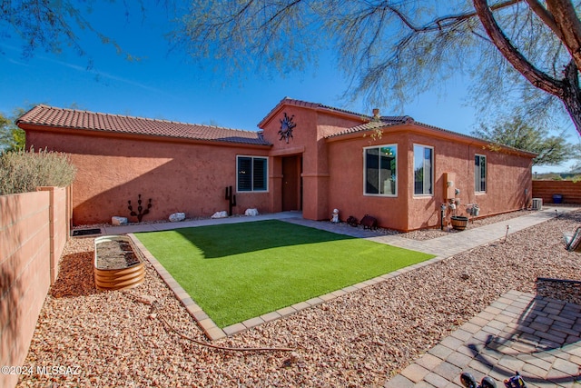 rear view of house with a lawn