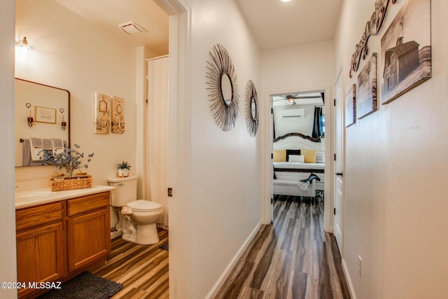 14286 E Lazy Jake Ln, Vail, AZ 85641 - hallway featuring a wall unit AC and dark wood-type flooring