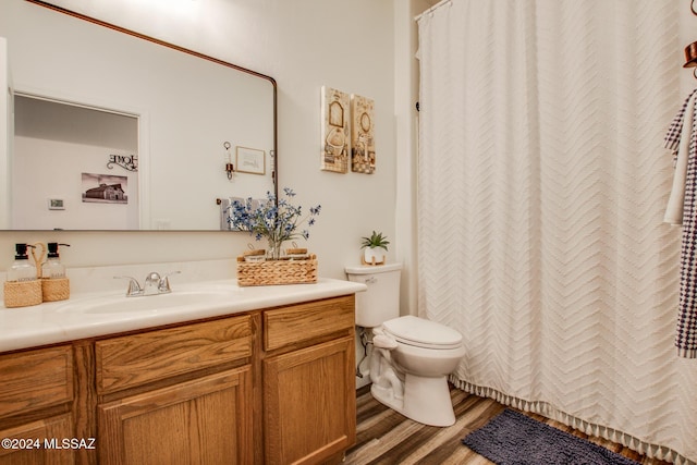 14286 E Lazy Jake Ln, Vail, AZ 85641 - bathroom with wood-type flooring, vanity, and toilet