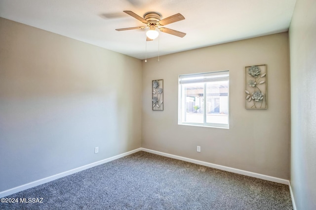 carpeted spare room featuring ceiling fan