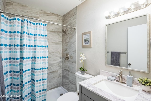 bathroom featuring vanity, toilet, and walk in shower