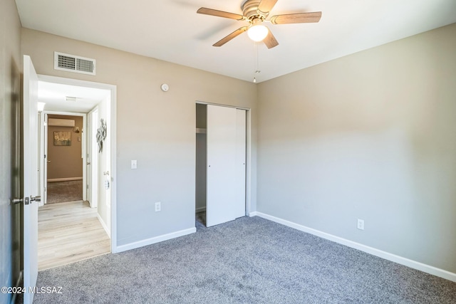 unfurnished bedroom with ceiling fan, a closet, and light colored carpet