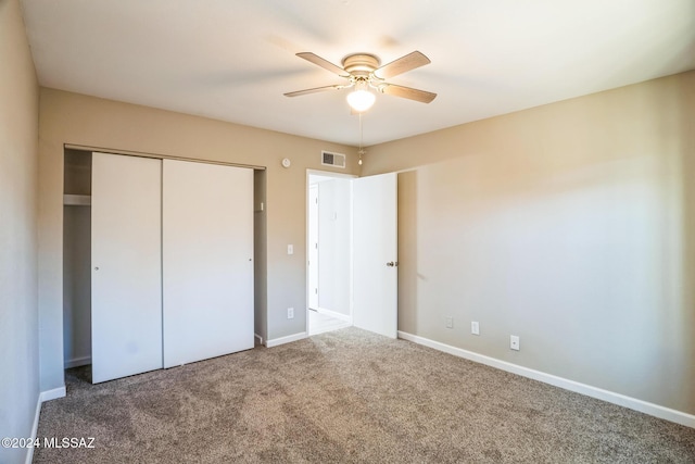 unfurnished bedroom featuring ceiling fan, a closet, and carpet floors