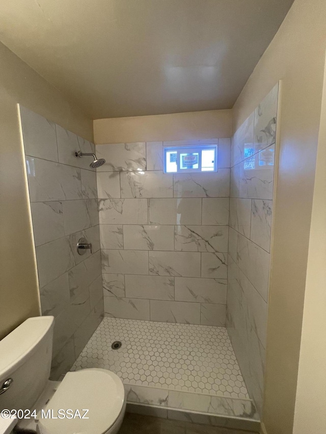 bathroom featuring toilet and tiled shower