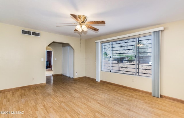 spare room featuring light hardwood / wood-style flooring and ceiling fan