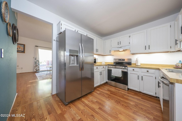 kitchen featuring light hardwood / wood-style floors, white cabinetry, sink, and appliances with stainless steel finishes