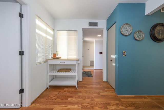 hallway with hardwood / wood-style flooring