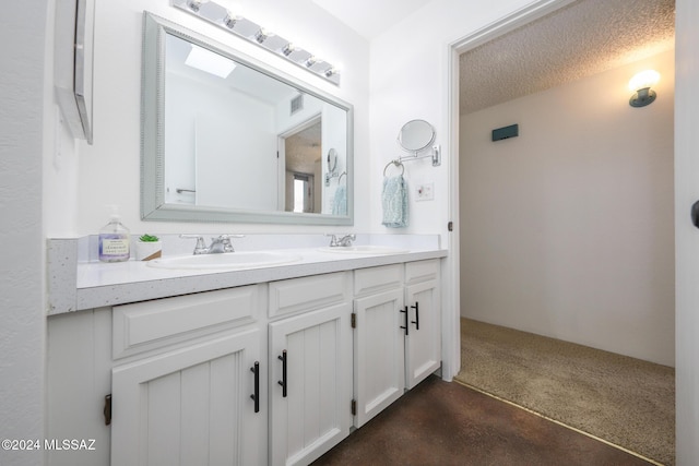 bathroom with vanity and a textured ceiling