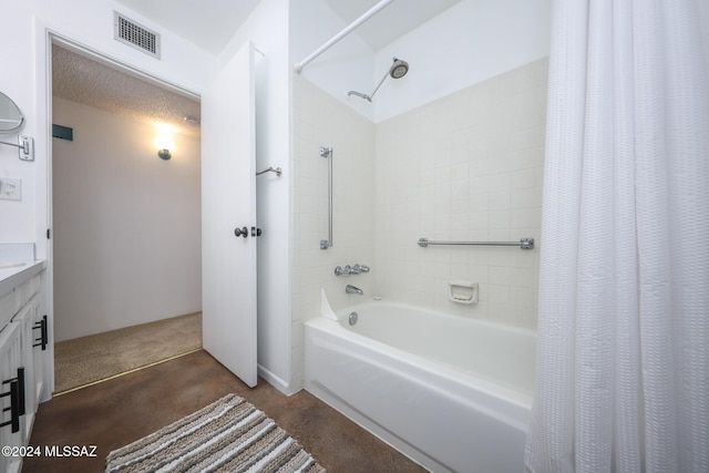 bathroom with a textured ceiling and shower / tub combo