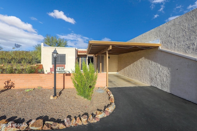 exterior space with a carport