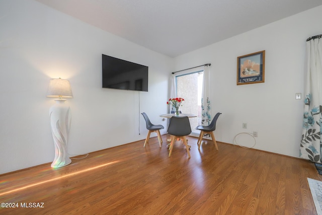 dining area with hardwood / wood-style flooring