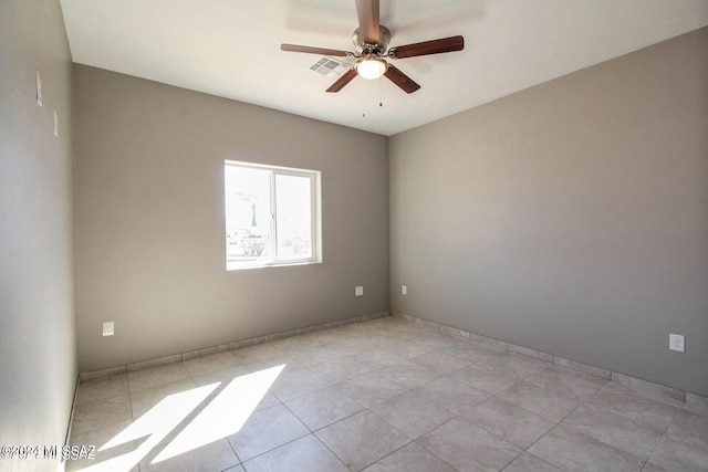 tiled empty room featuring ceiling fan