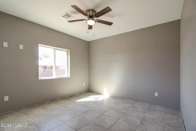 empty room with light tile patterned floors and ceiling fan