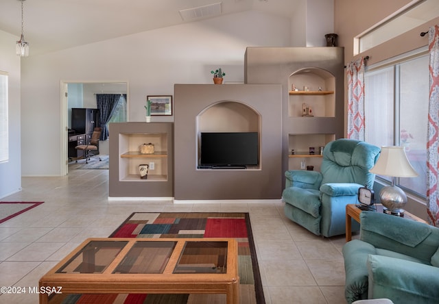 tiled living room featuring built in shelves and vaulted ceiling