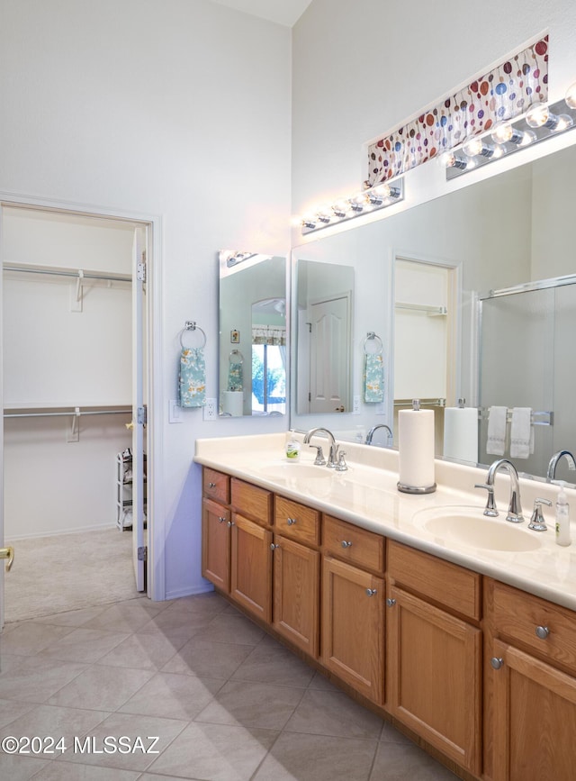 bathroom with vanity, tile patterned floors, and walk in shower