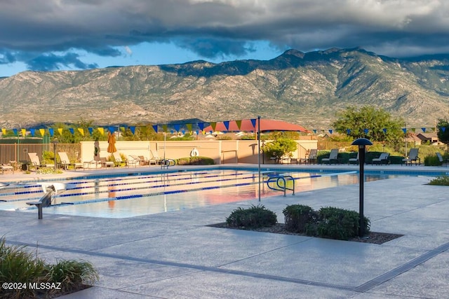 view of swimming pool with a mountain view