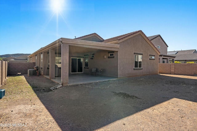 rear view of property with a patio area and central air condition unit