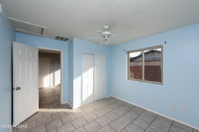 Tucson, AZ 85756 - unfurnished bedroom with a closet, light tile patterned flooring, attic access, and ceiling fan