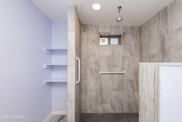 Tucson, AZ 85756 - bathroom featuring a tile shower and baseboards