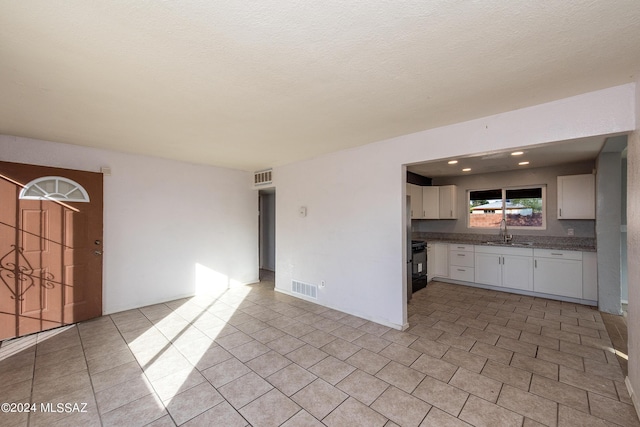 Tucson, AZ 85756 - kitchen featuring white cabinetry, range, and light tile patterned floors