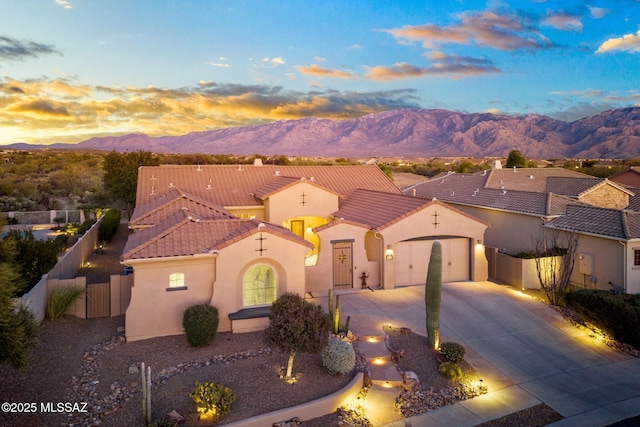 mediterranean / spanish home featuring a garage and a mountain view