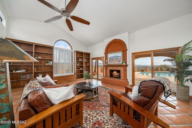 tiled living room with ceiling fan and vaulted ceiling