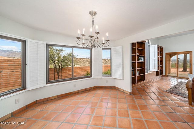 unfurnished dining area featuring tile patterned flooring, an inviting chandelier, and a healthy amount of sunlight