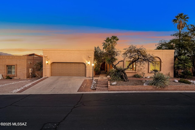 pueblo-style home featuring a garage