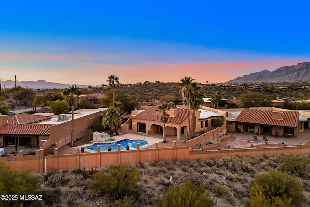 aerial view at dusk featuring a mountain view