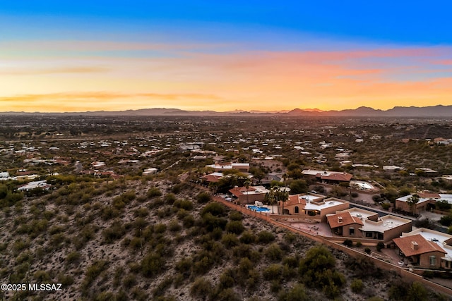 aerial view at dusk featuring a mountain view