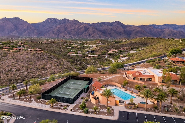 aerial view at dusk featuring a mountain view