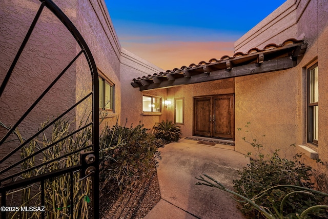 view of exterior entry at dusk