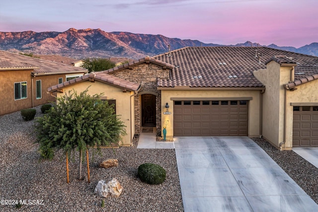 mediterranean / spanish house featuring a mountain view and a garage