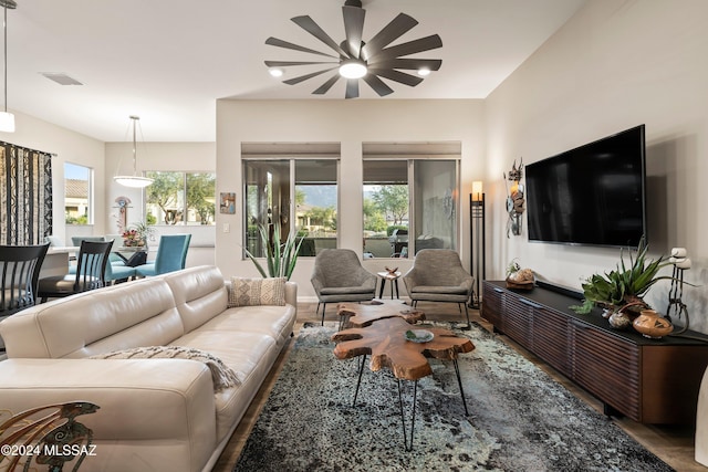 living room with ceiling fan, wood-type flooring, and plenty of natural light