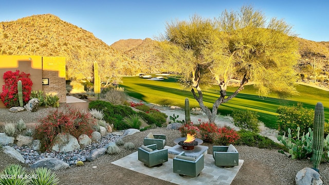 view of community with a mountain view and a yard